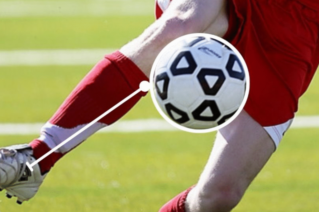 Football player demonstrating proper first touch technique while receiving the ball during training